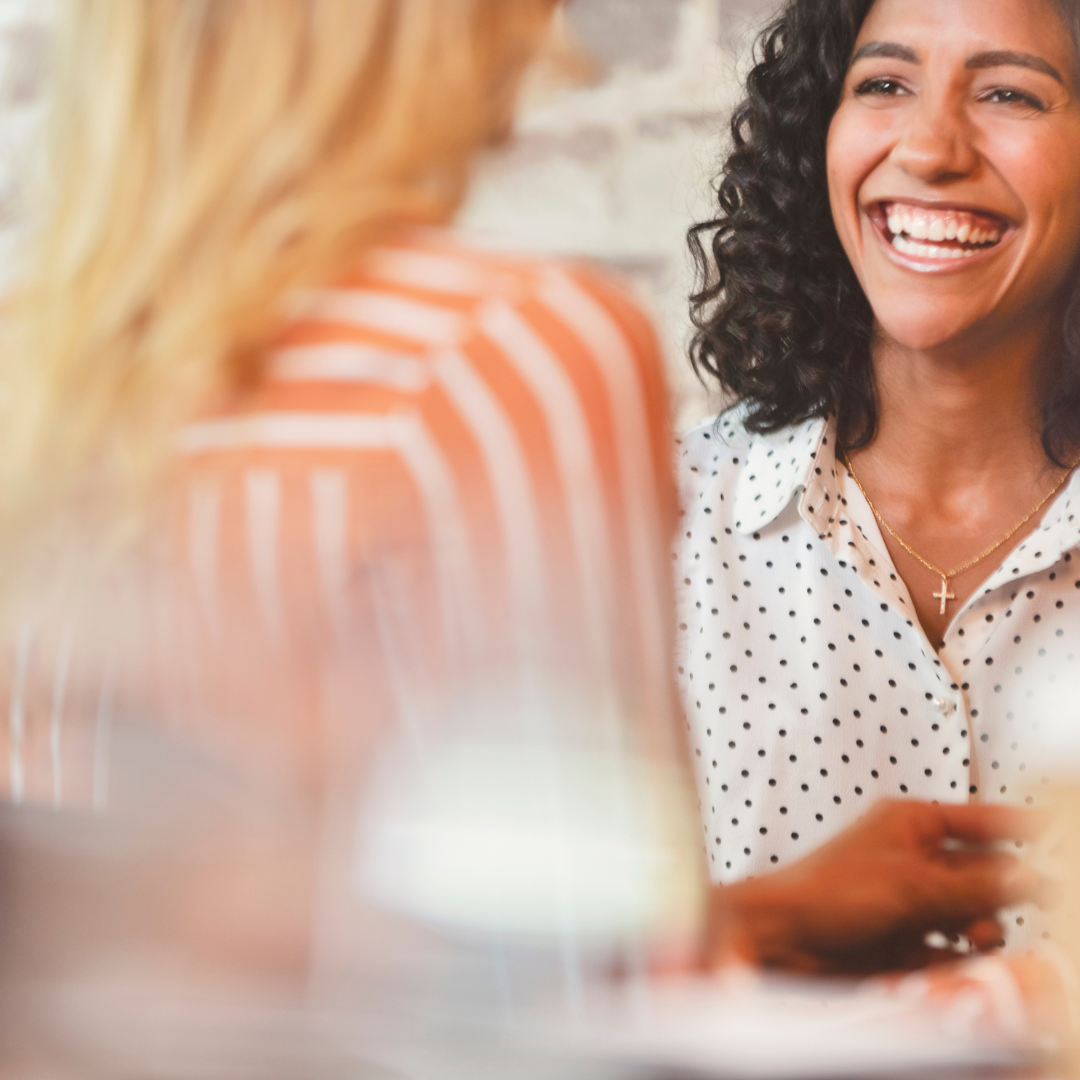 Two women smiling and talking