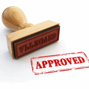 Wooden stamp with red 'Approved' mark.