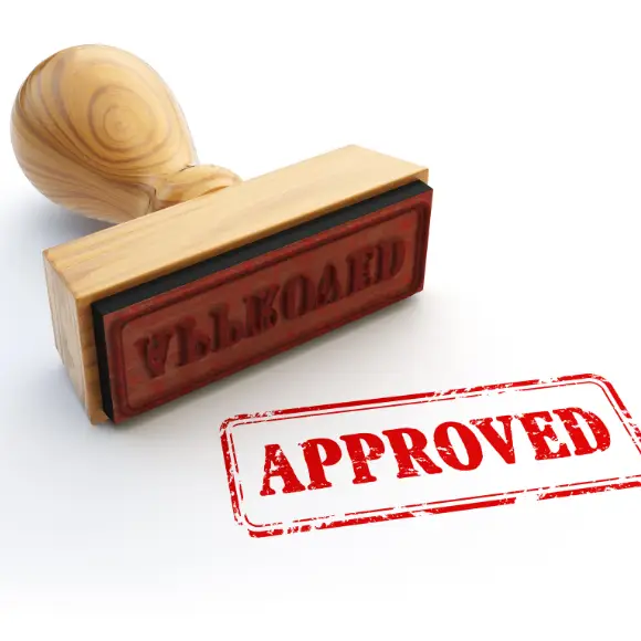 Wooden stamp with red 'Approved' mark.