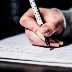 Handwriting notes on graph paper with pen