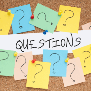 Colorful question marks and 'questions' text on corkboard.