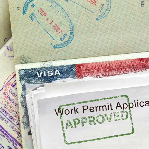Approved U.S. work permit and visa stamps.