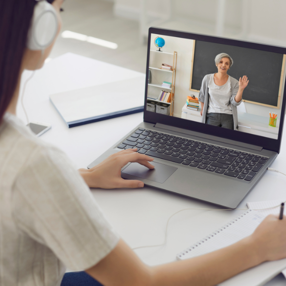 Student attending online class on laptop