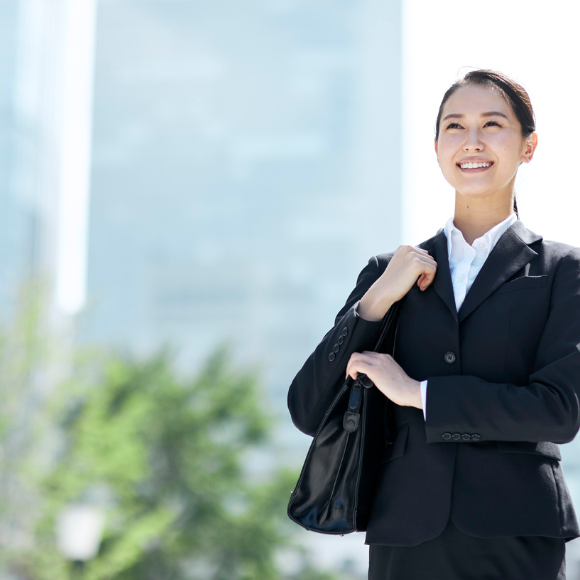 Businesswoman smiling outdoors in urban setting