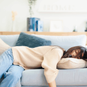 Woman sleeping on couch in living room.